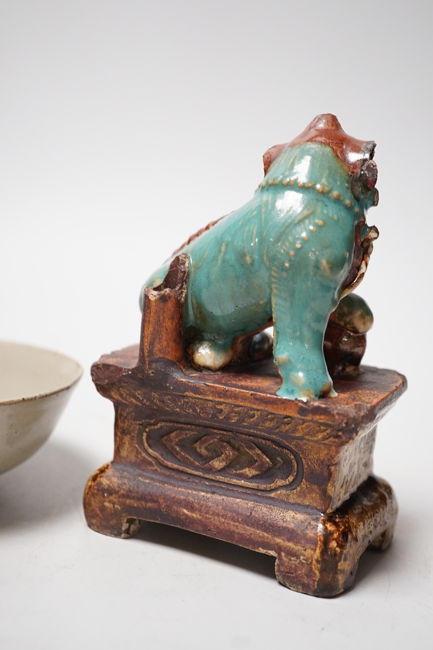 A 19th century Chinese Shiwan figure of a lion-dog and celadon glazed shallow bowl. Tallest 14cm